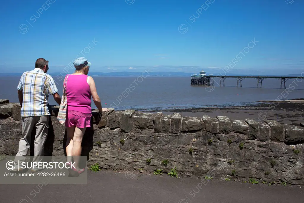 England, Dorset, Clevedon. Couple looking over Clevedon beach.