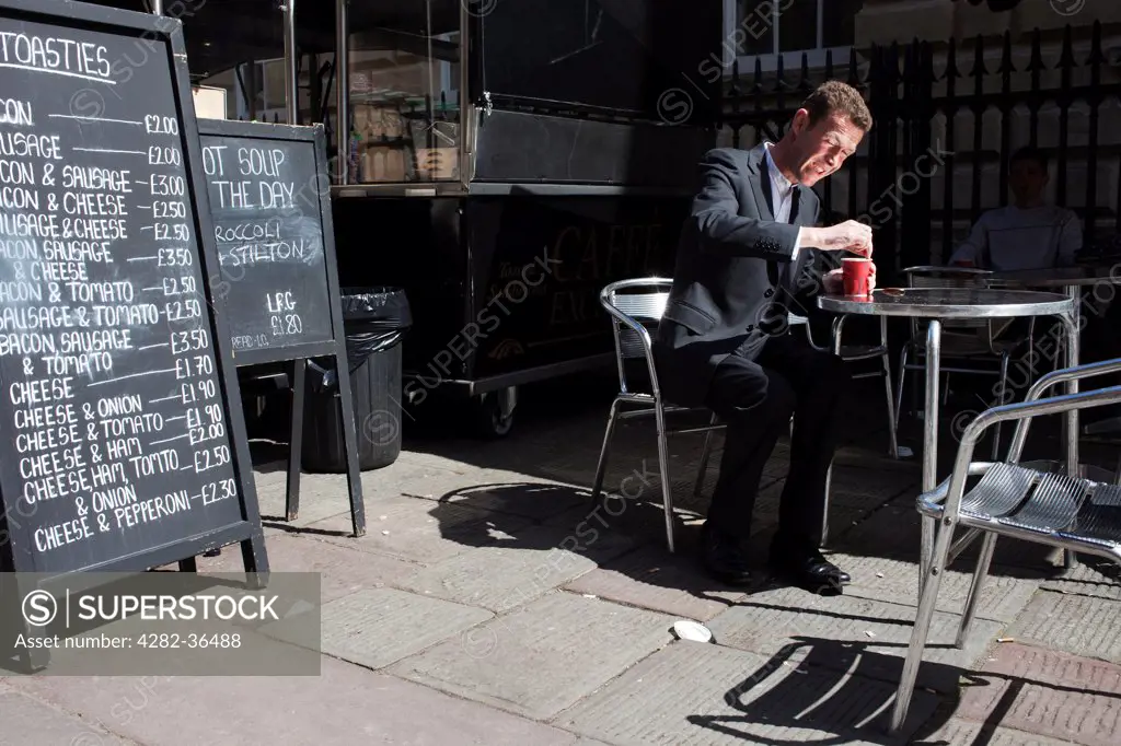 England, Bristol, Bristol. Man having a coffee.