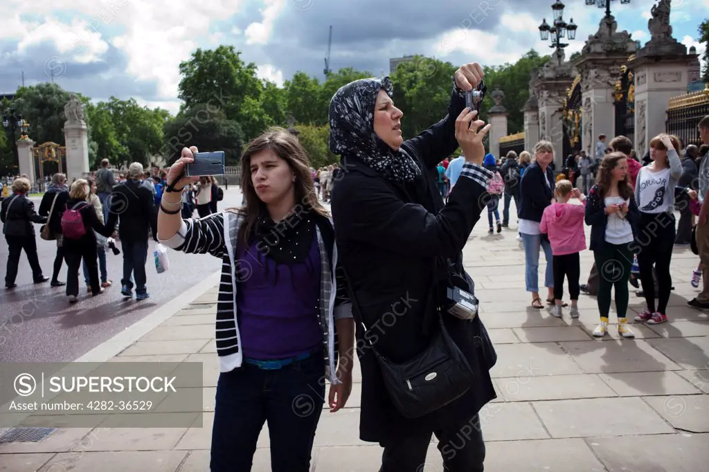 England, London, Buckingham Palace. Tourists around Buckingham Palace.