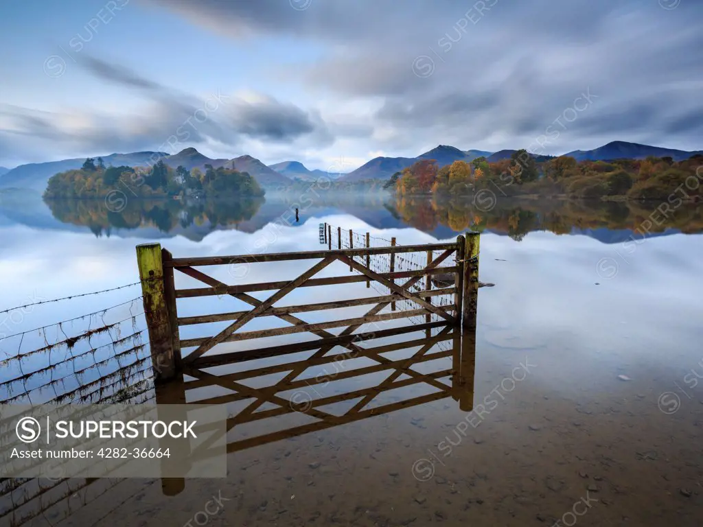 England, Cumbria, Keswick. A gate and fence in a flooded field by Derwent Water near Keswick.
