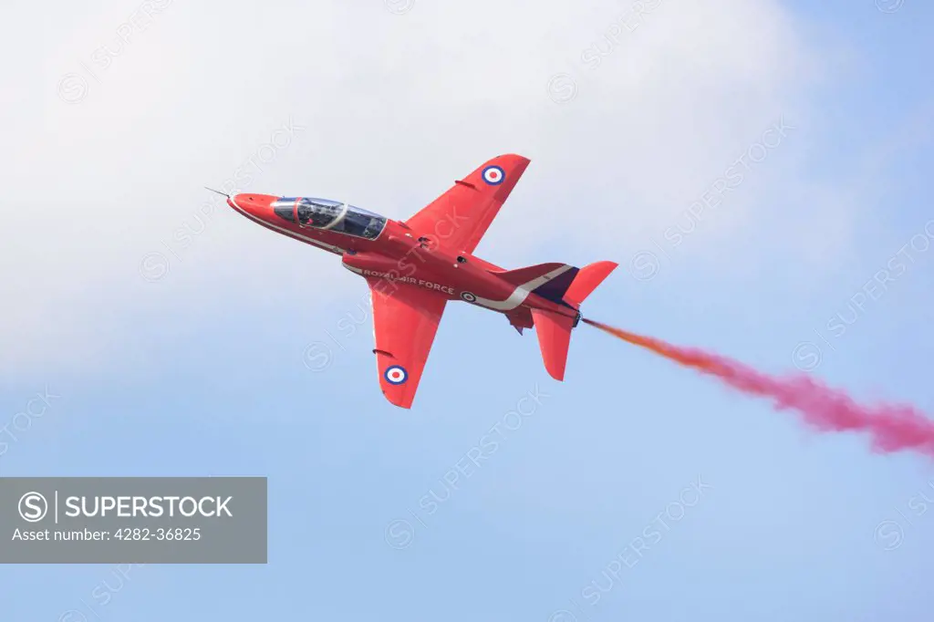 England, Somerset, Yeovilton. RAF Red Arrow Hawk displaying at RNAS Yeovilton Airday 2012.