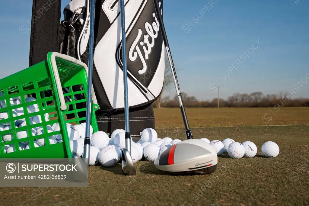England, North Yorkshire, York. Golf clubs and golf balls on a driving range.