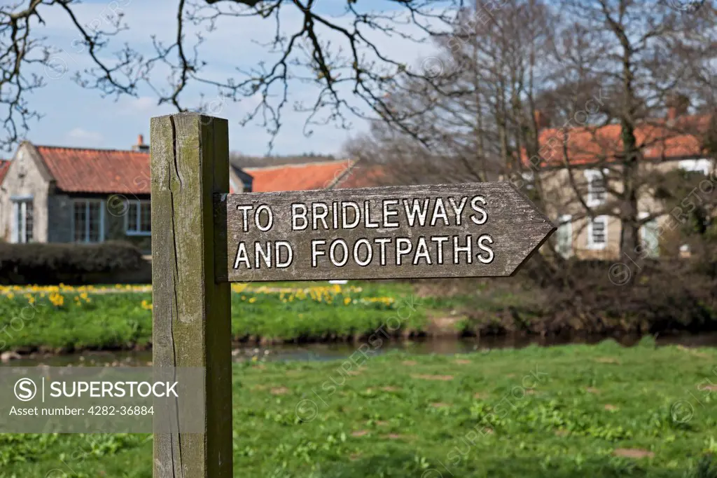 England, North Yorkshire, Sinnington. Wooden signpost pointing to bridleways and footpaths.