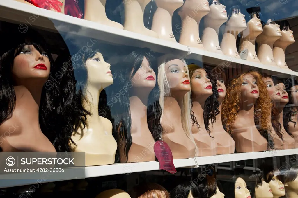 England, North Yorkshire, York. Wigs on display in a shop window.