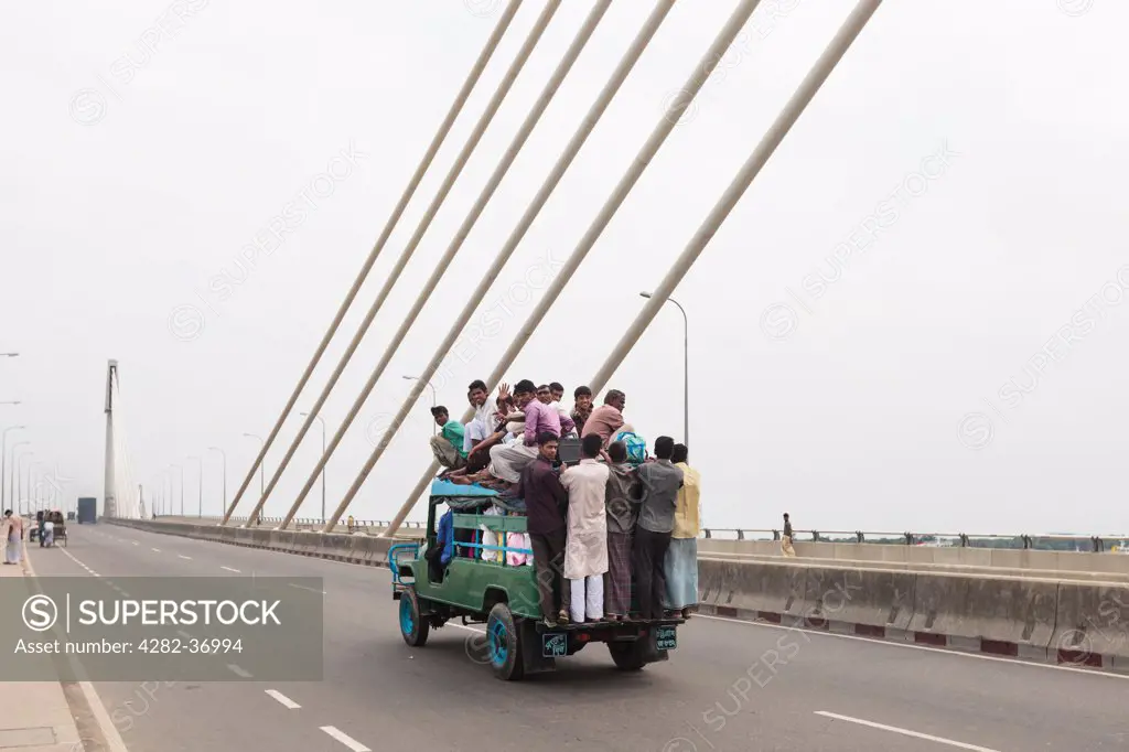 Bangladesh, Chittagong, River Karnaphuli. Overloaded jeep on a bridge over the River Karnaphuli.