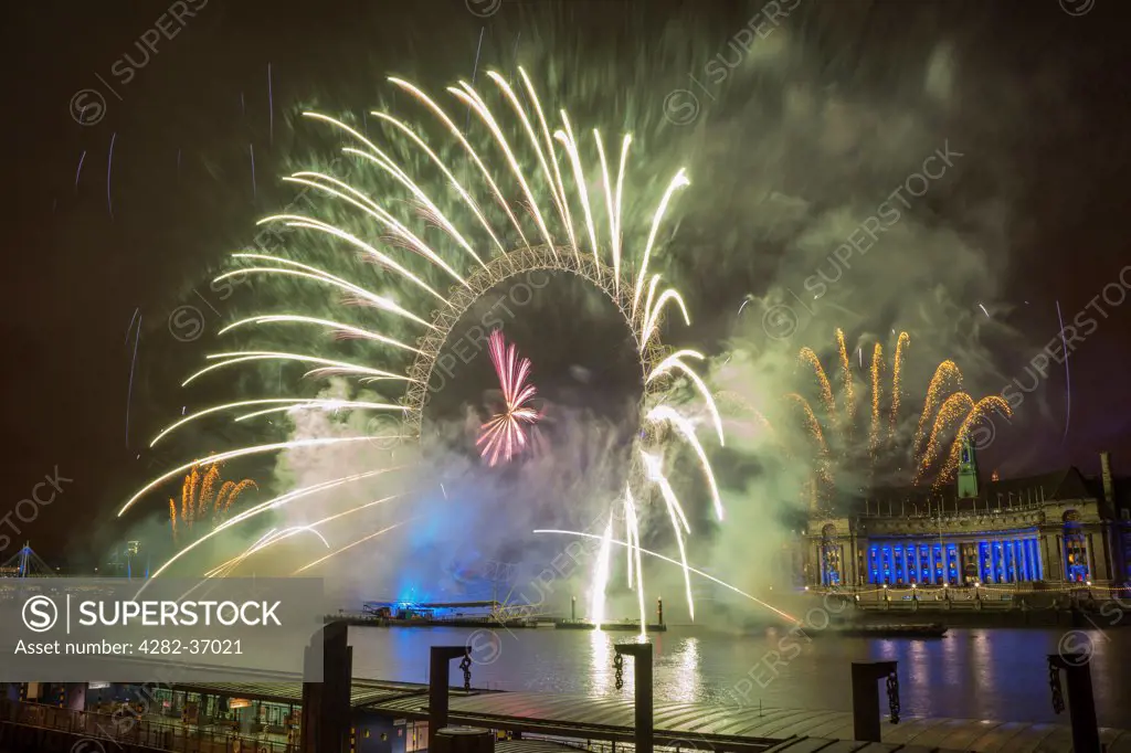 England, London, South Bank. Fireworks over the London Eye during the New Years celebrations.
