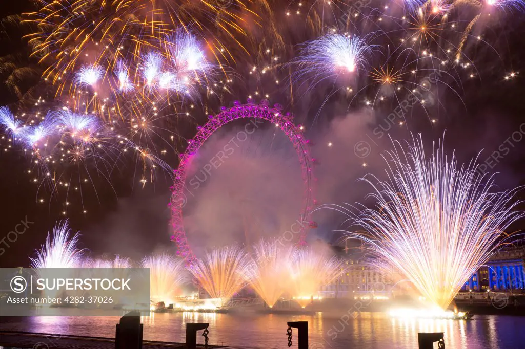 England, London, South Bank. Fireworks over the London Eye during the New Years celebrations.