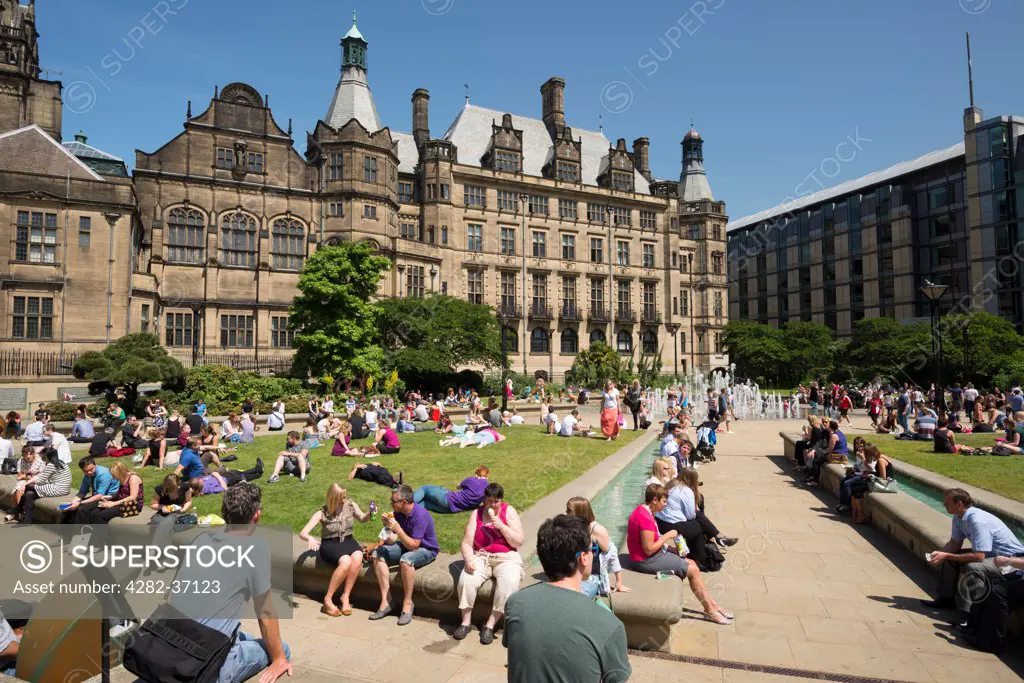England, South Yorkshire, Sheffield. People relaxing in Peace Gardens in Sheffield.