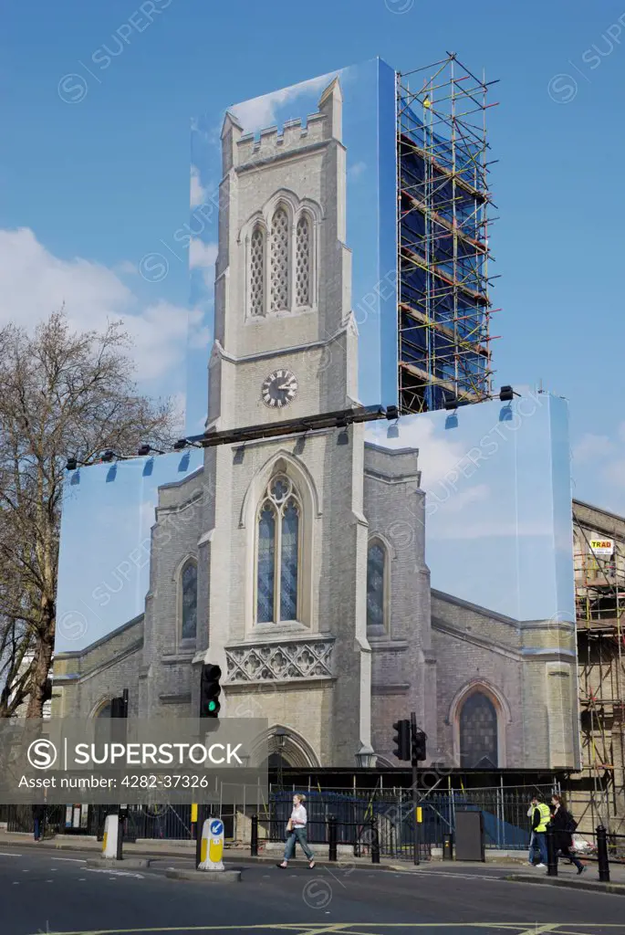 England, London, Fulham. A giant photograph hiding scaffolding on St John's Church in Fulham.