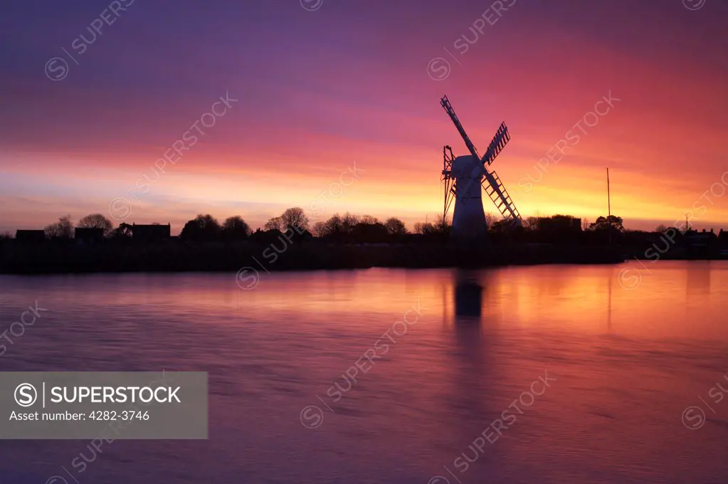 England, Norfolk, Thurne. A view toward Thurne Windmill at dawn on the Norfolk Broads National Park.