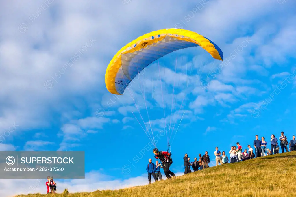England, Cumbria, Keswick. Paraglider on Latrigg summit in the Lake District National Park.