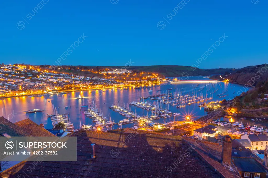 England, Devon, Dartmouth. Boats moored on the river Dart with Dartmouth in the background.