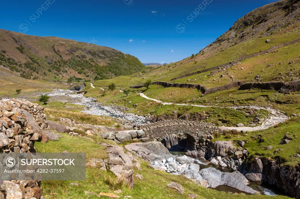 England, Cumbria, Seathwaite. Stockley Bridge which is a traditional packhorse bridge over Grains Gill in the Borrowdale Valley.