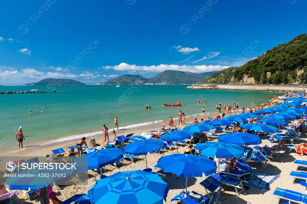 Italy, Liguria, Lerici. Tourists on the beach at Lerici.