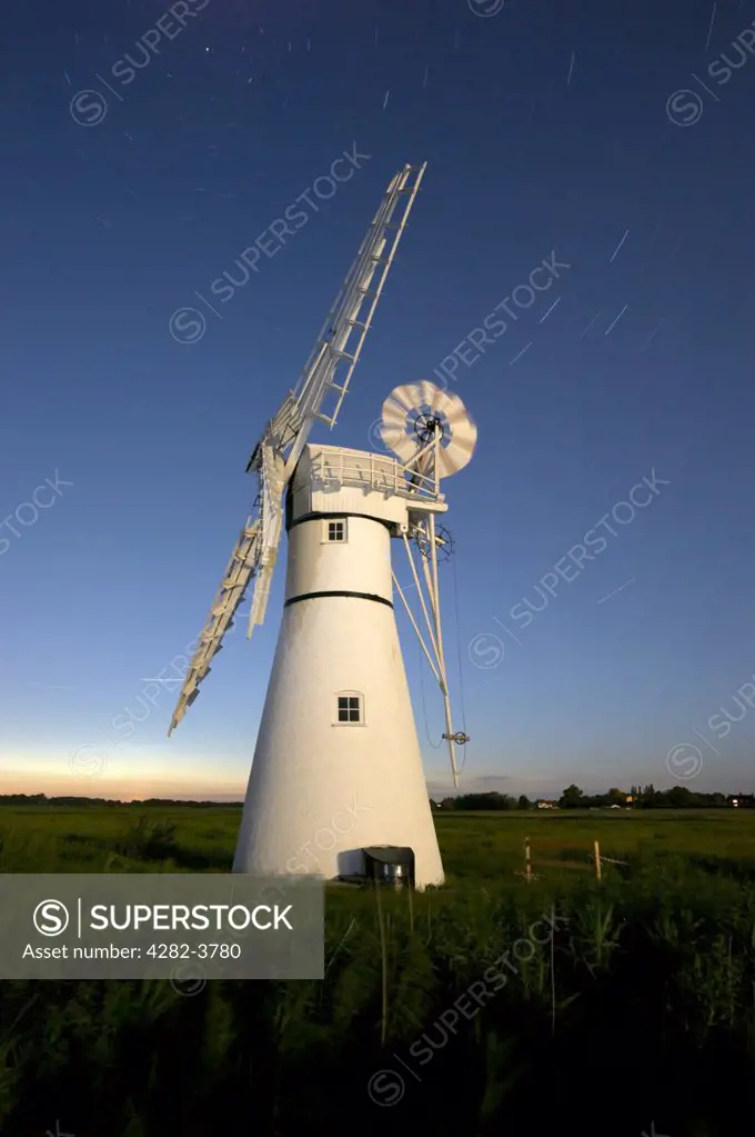 England, Norfolk, Thurne Windmill. Thurne Windmill at night with star trails.