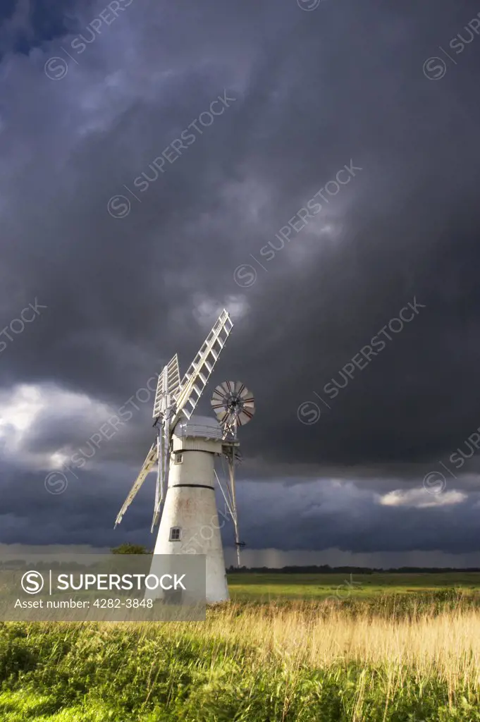 England, Norfolk, Thurne Windmill. Thurne Windmill against a stormy sky on the Norfolk Broads.