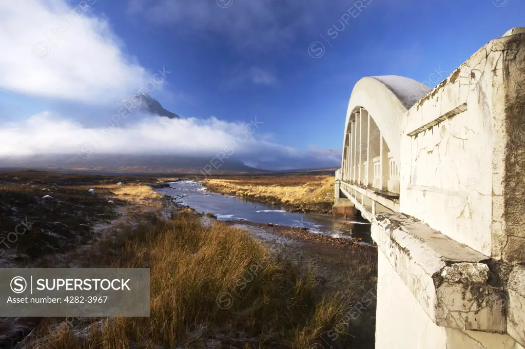 Scotland, Highland, Glen Etive. Cloud covers Buachaille Etive Mor Mountain viewed from a bridge  spanning the River Etive.