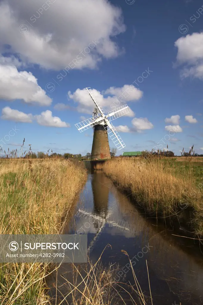 England, Norfolk, Thurne. Reflections in the water of St. Benets Level windpump on the Norfolk Broads.