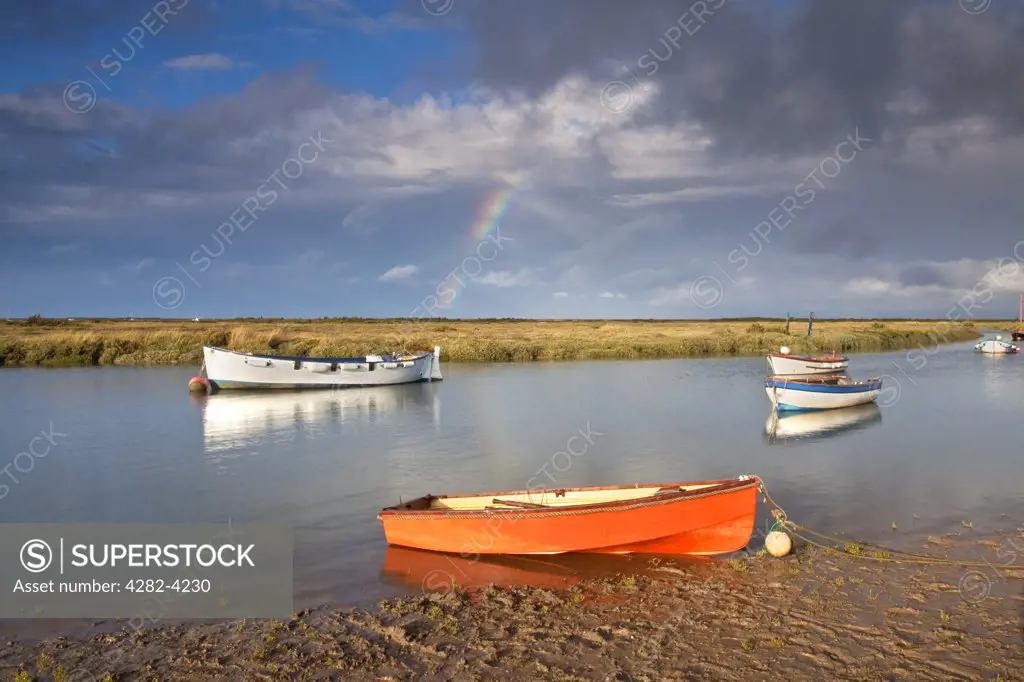 England, Norfolk, Morston. A rainbow over the small fishing harbour at Morston on the North Norfolk Coast.
