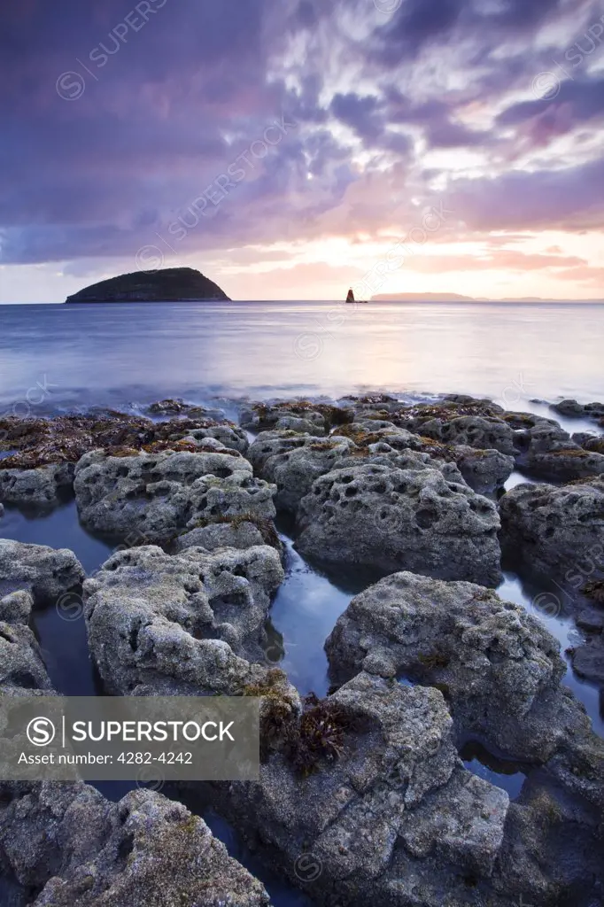 Wales, Isle of Anglesey, Puffin Island. Dawn view of Puffin Island, a Special Protection Area (SPA), largely because of its Great Cormorant colony, off the coast of Anglesey in North Wales.