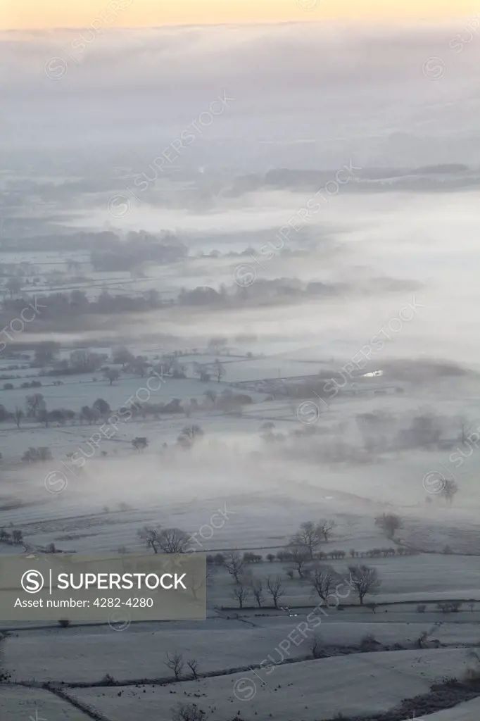 England, Derbyshire, Hope Valley. The Hope Valley shrouded in mist at dawn in the Peak District National Park.