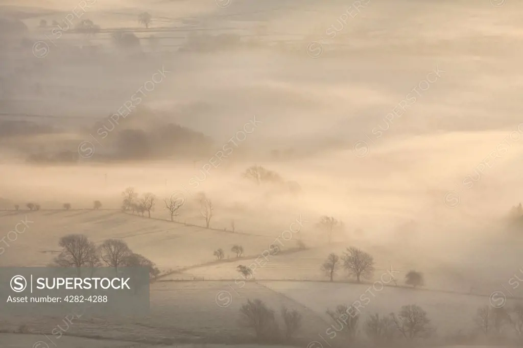 England, Derbyshire, Hope Valley. The Hope Valley shrouded in mist at dawn in the Peak District National Park.