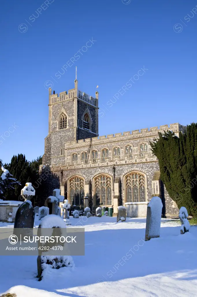 England, Suffolk, Stratford St. Mary. The traditional flint church of St Mary in the village of Stratford St. Mary after a heavy winter snowfall.