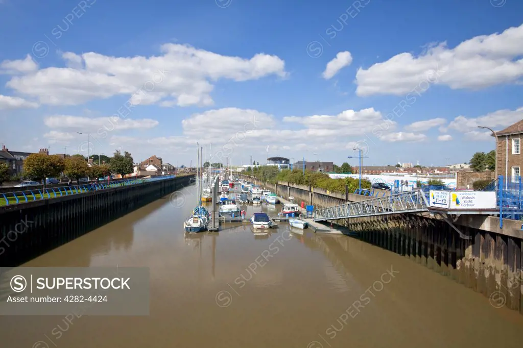 England, Cambridgeshire, Wisbech. Boats moored by jetties in the Wisbech Yacht Harbour on the River Nene.