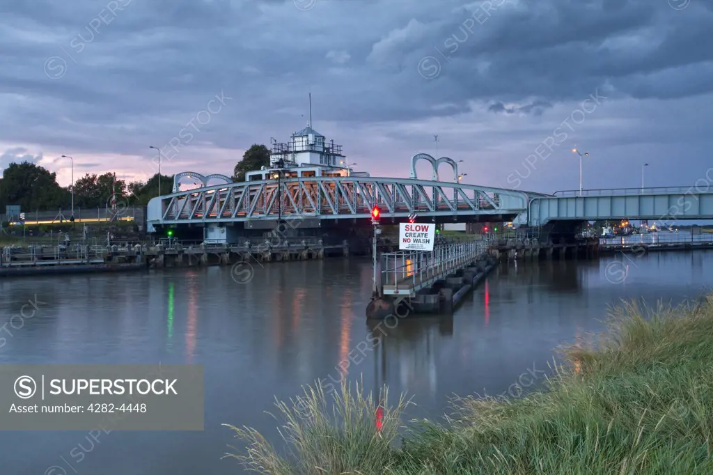 England, Lincolnshire, Sutton Bridge. Crosskeys Bridge built in 1897 spanning the River Nene. The bridge is a swing bridge and used for road traffic though originally it was intended to be dual purpose for use also as a railway crossing until the line was closed in 1965.