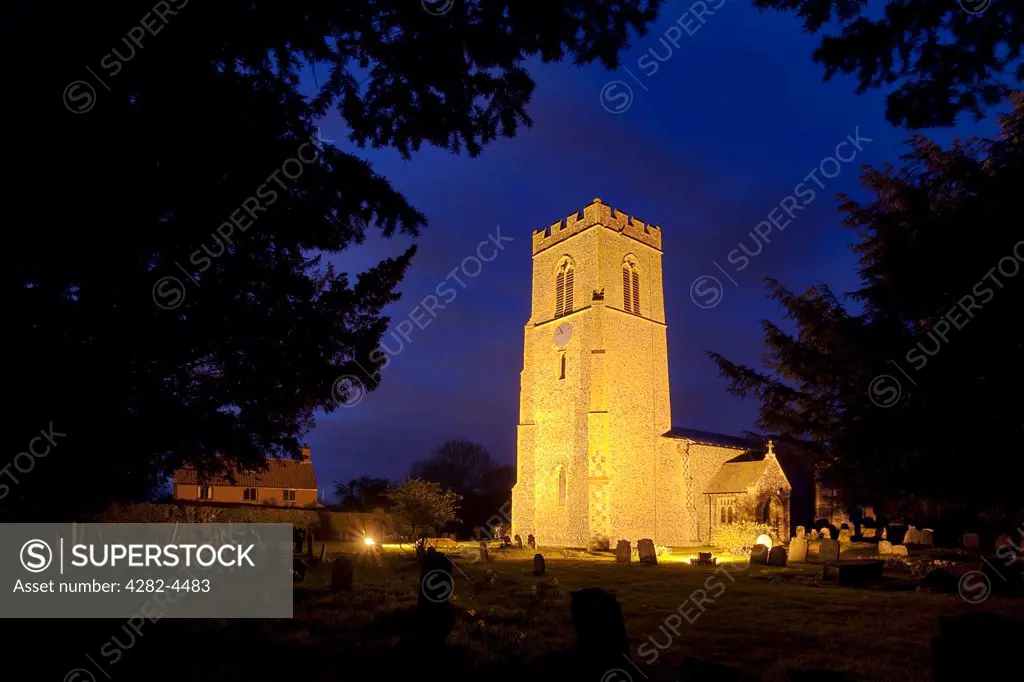England, Norfolk, Mulbarton. St Mary Magdalen church, parts of which date back to the late 14th century, illuminated at night.