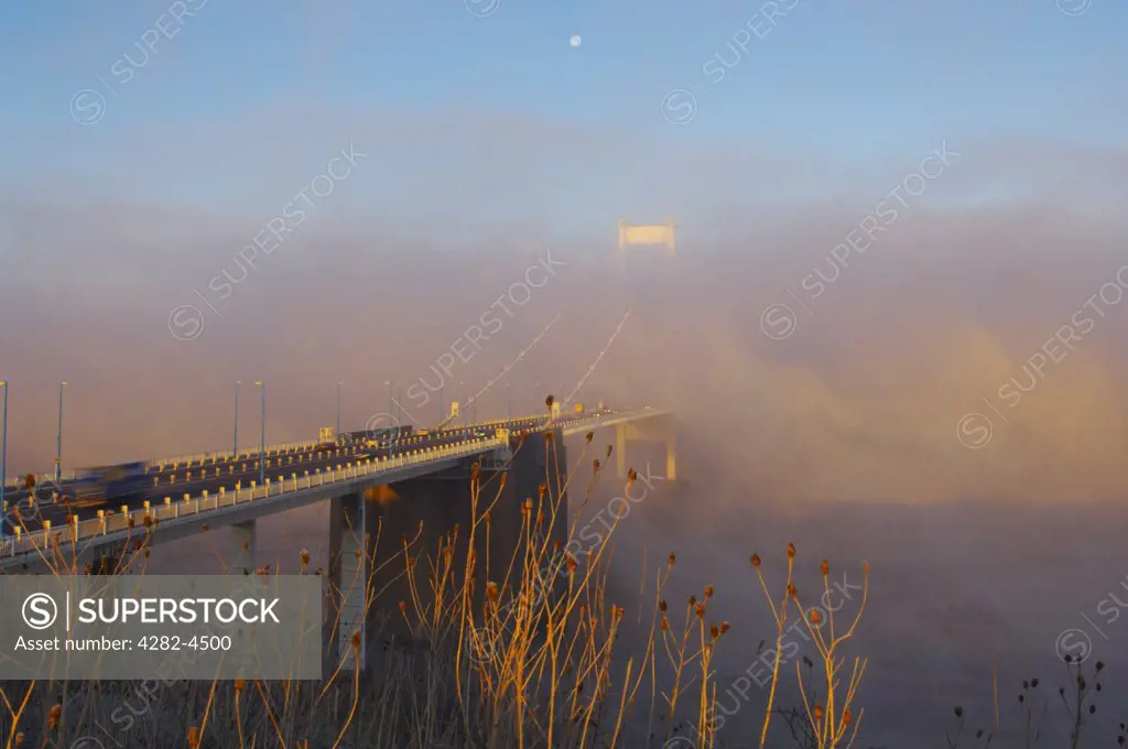 England, Gloucestershire, Aust. The Severn Bridge from the English side in morning fog.