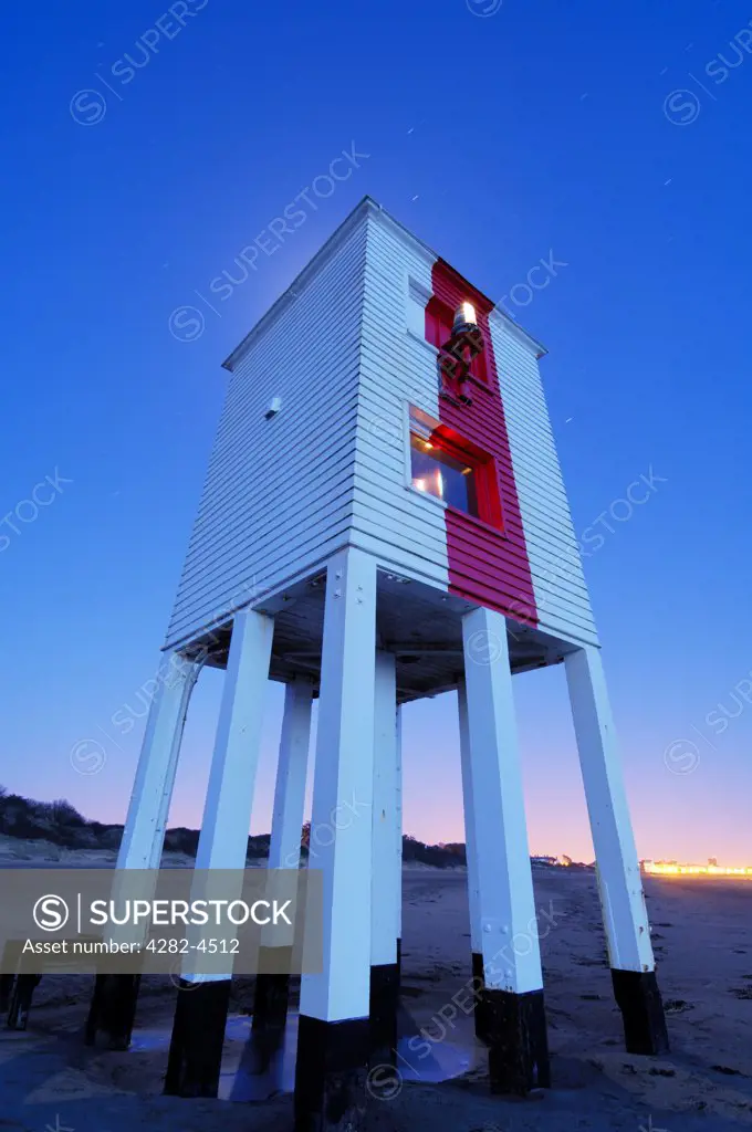 England, Somerset, Burnham-on-Sea. The lighthouse at Burnham-on-Sea at dusk. Built in 1832 it remained inactive from 1969 for 27 years and then the wooden lighthouse was reactivated in 1996 and is still in use today.