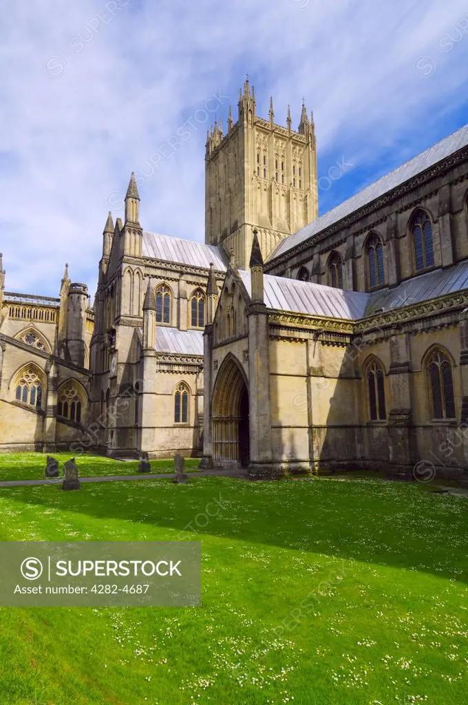 England, Somerset, Wells. The North side of Wells Cathedral. The smallest city in England Wells derived it's name from the natural wells that supply water to the area from the nearby Mendip Hills.