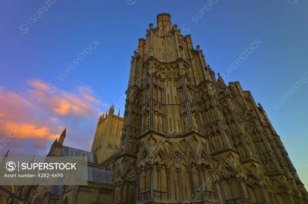 England, Somerset, Wells. The northwest corner of Wells Cathedral  at dusk. The smallest city in England, Wells derived it's name from the natural wells that supply water to the area from the nearby Mendip Hills.