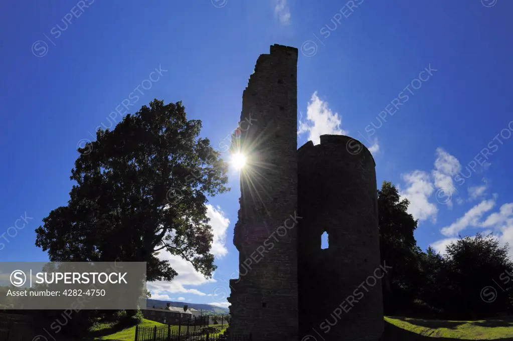 Wales, Powys, Crickhowell. The silhouetted ruin of Crickhowell Castle. The original 12th century motte and bailey timber construction was rebuilt in stone in 1272. It was destroyed in the 15th century by Owain Glyndwr's forces.