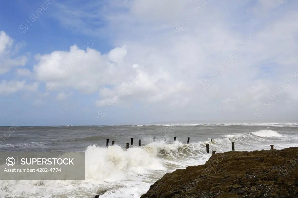 England, Devon, Westward Ho!. A stormy sea battering the supports of the old pier at Westward Ho!  The old Victorian pier was destroyed shortly after completion by Atlantic storms.