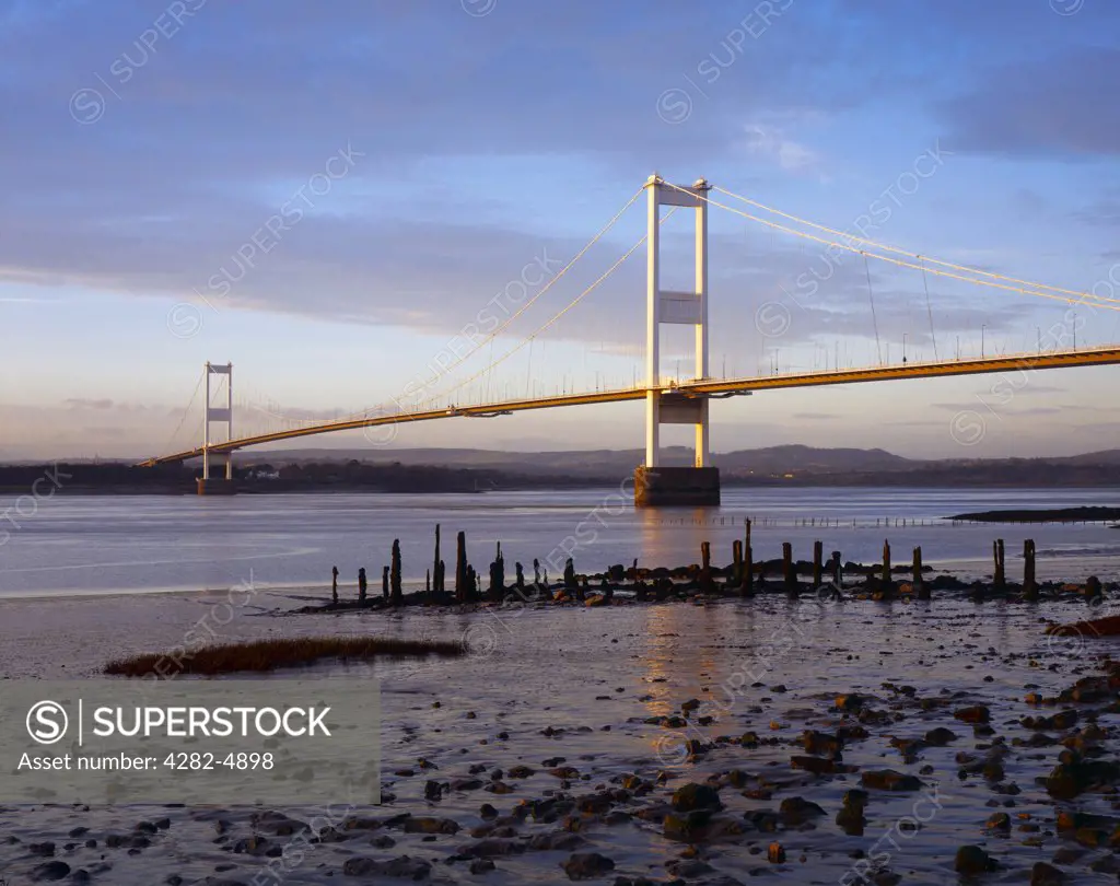 England, Gloucestershire, Aust. A view from the beach to The Severn Bridge over the River Severn Estuary at Aust.