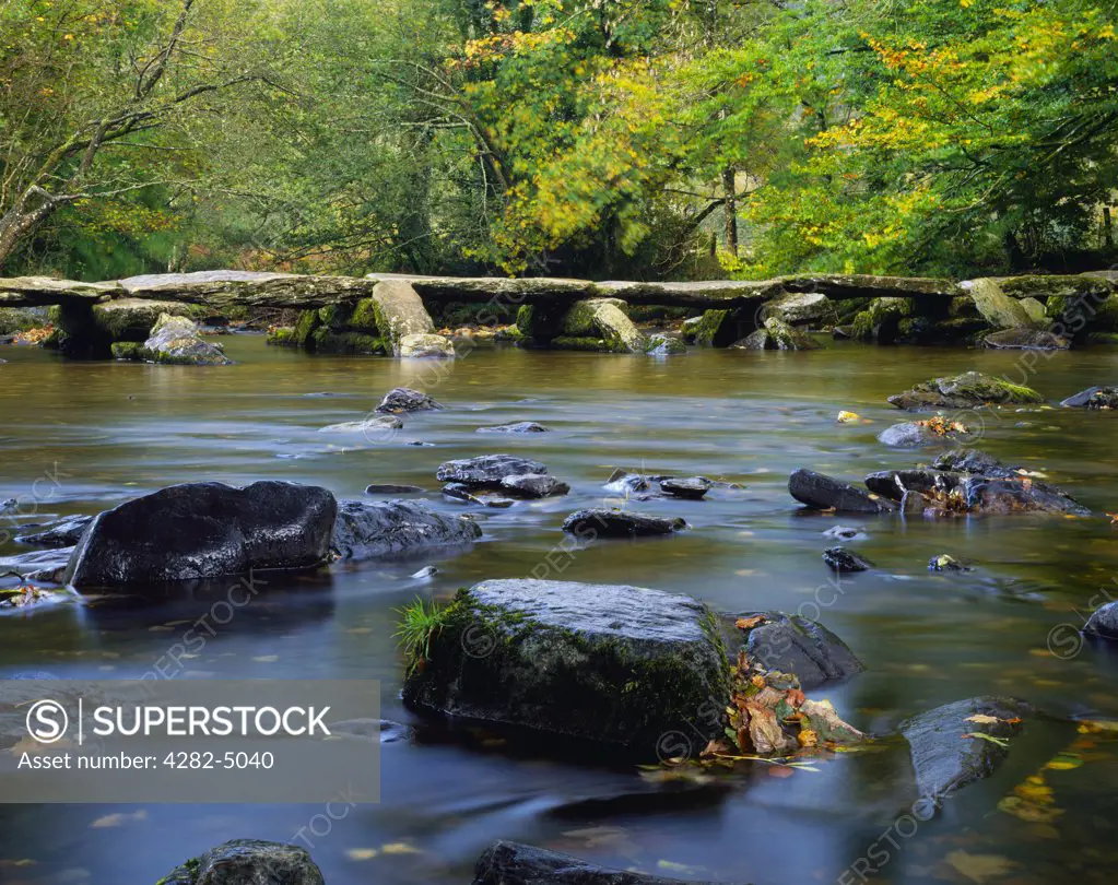 England, Somerset, Liscombe. The prehistoric clapper bridge of Tarr Steps over the river Barle in Exmoor National Park near Liscombe.