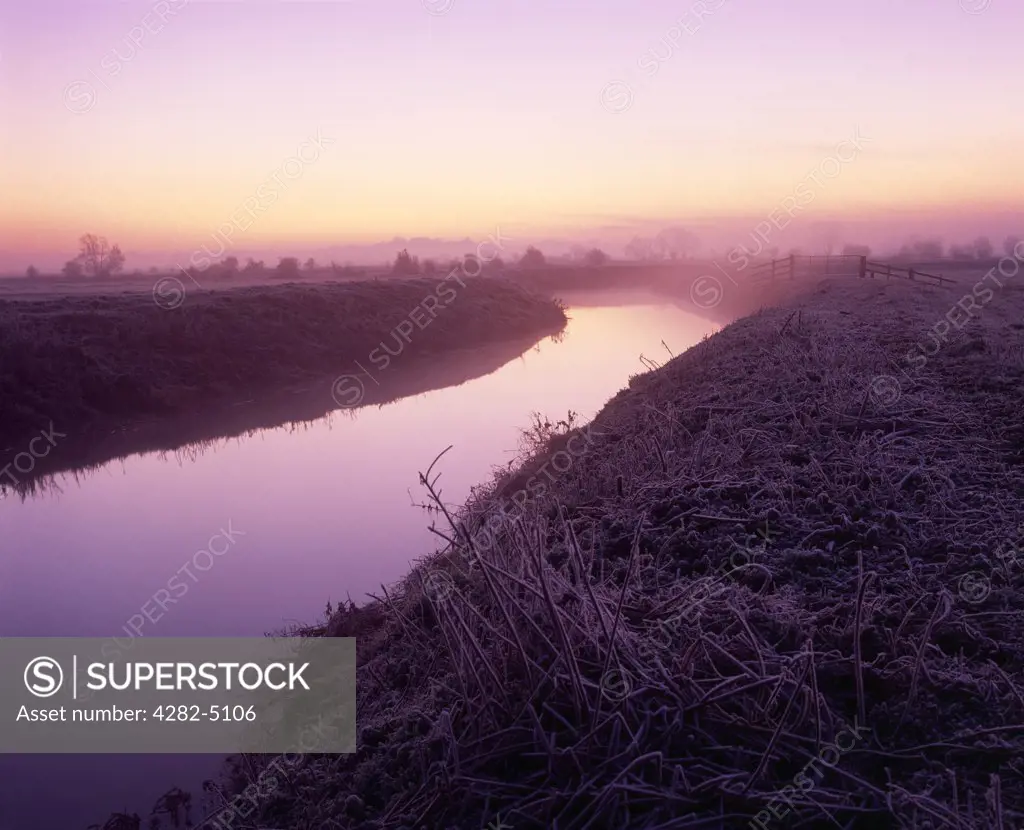 England, Somerset, Glastonbury. The River Brue at dawn on South Moor on the Somerset Levels at Glastonbury, Somerset.