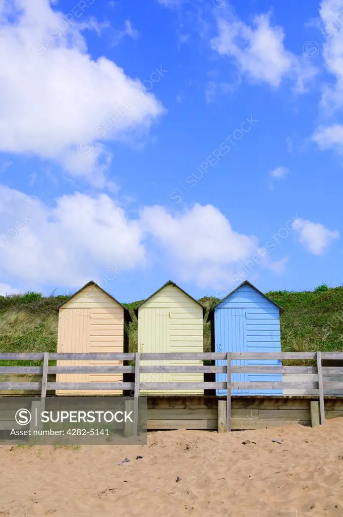 England, Cornwall, Bude. Colourful beach huts at Summerleaze Beach in Bude.