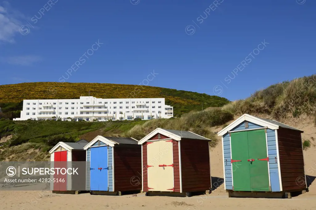 England, Devon, Braunton. The Saunton Sands Hotel overlooking the beach huts at Saunton near Braunton on the North Devon coast.