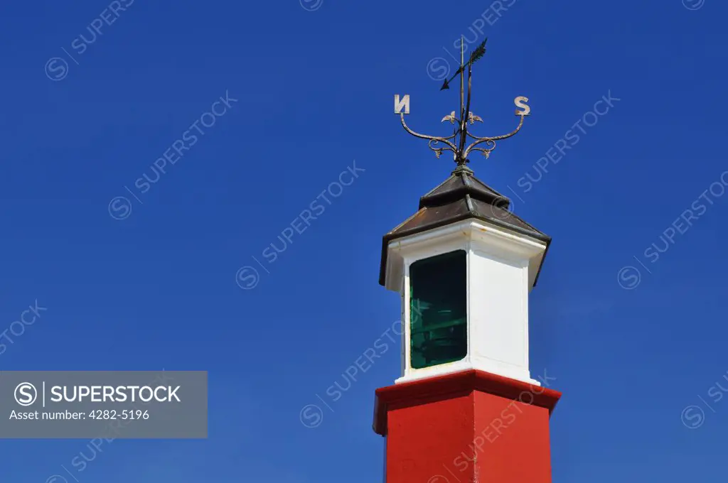 England, Somerset, Watchet. A weather vane on top of the Watchet Harbour Lighthouse, a navigational aid on the East Pier at the entrance to the marina at Watchet Harbour.