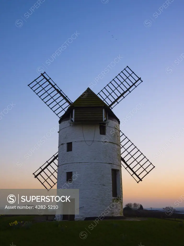England, Somerset, Chapel Allerton. Ashton Windmill, a tower mill dating from the 18th century, at dusk.