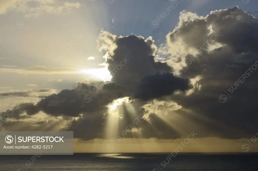 England, Devon, Ilfracombe. Sunbeams bursting through cloud at sunset over the Bristol Channel near Ilfracombe.