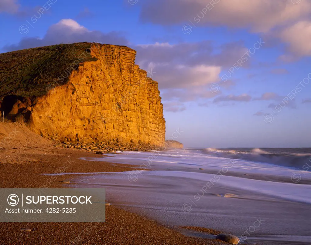 England, Dorset, Bridport. The shingle beach and East Cliff at West Bay near Bridport on the Dorset Jurassic Coast.