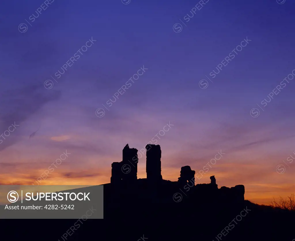 England, Dorset, Corfe Castle. Silhouette of the ruins of Corfe Castle near Swanage and Wareham on the Isle of Purbeck.