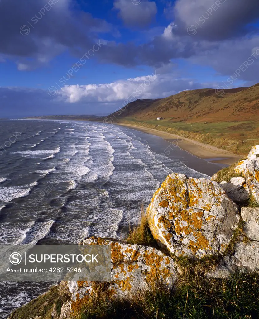 Wales, Swansea, Rhossili. Waves rolling onto the beach at Rhossili Bay on the Gower peninsula.