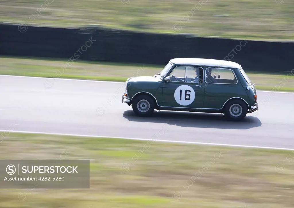 England, West Sussex, Goodwood Revival. Green Mini Cooper on race track at Goodwood Revival.