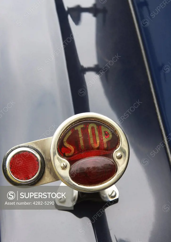 England, West Sussex, Goodwood Revival. Stop light reflector on back of classic car at Goodwood Revival.