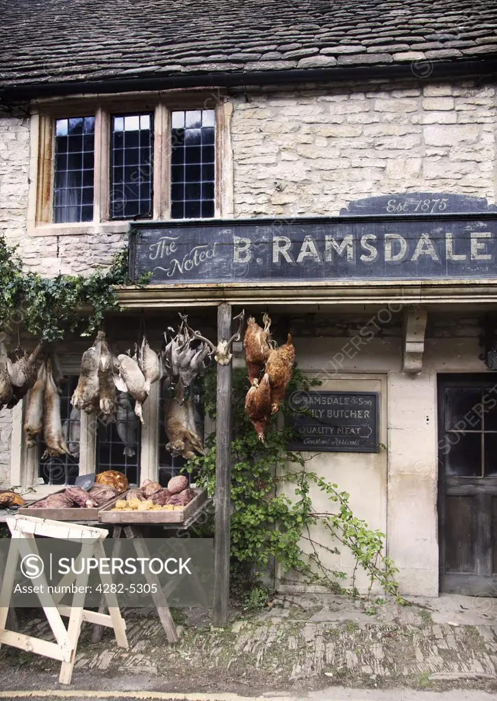 England, Wiltshire, Castle Combe. A view towards the front of a butcher shop in Castle Combe.